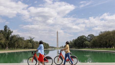 Biking on the National Mall in Washington, D.C., with the Washington Monument in the background Biking on the National Mall in Washington, D.C., with the Washington Monument in the background