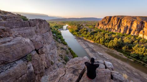 Hiker taking in views of the Rio Grande in Big Bend National Park, Texas Hiker taking in views of the Rio Grande in Big Bend National Park, Texas